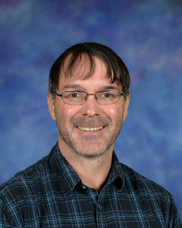 a man wearing a hat and glasses