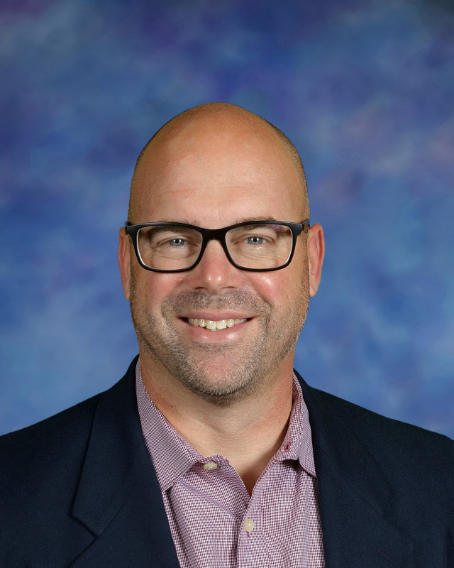 a man wearing a hat and glasses